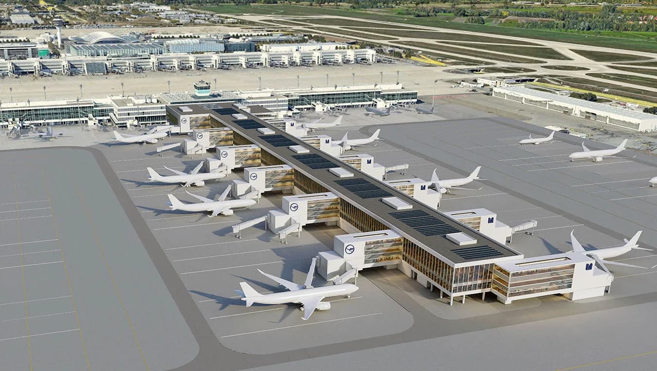 Luftaufnahme Terminal mit mehreren geparkten Lufthansa-Maschinen am Flughafen München und angegliederten Fluggates